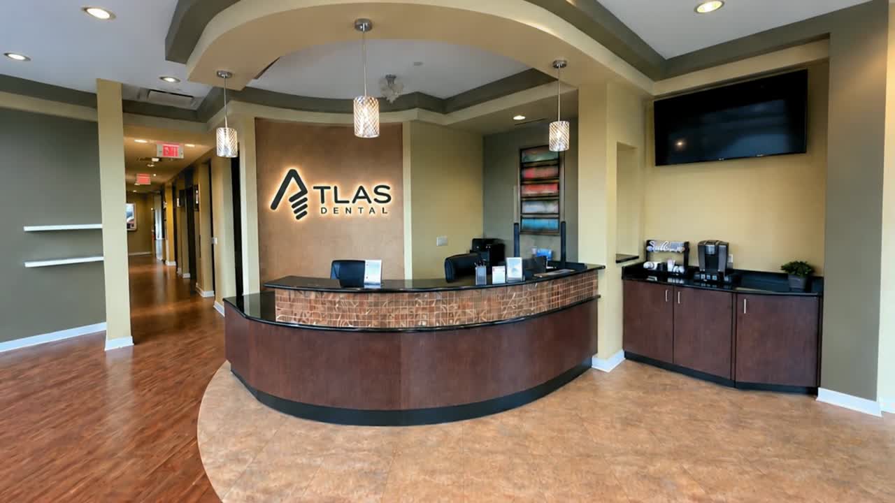 Atlas Dental reception area and illuminated office sign